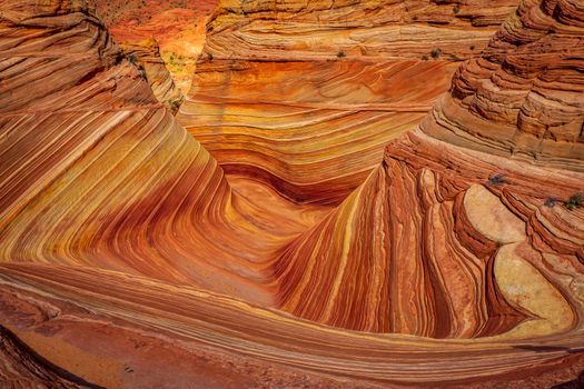 The Wave is a famous sandstone rock formation located in Coyote Buttes, Arizona, known for its colorful, undulating forms