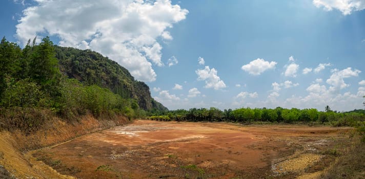 The pond is dry until you see the ground. During the dry season
Blue sky and white clouds , Tons of wood covered