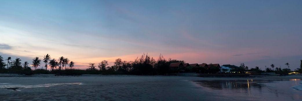Panorama ,Coconut trees and trees separating the beach "Chao Samran" and the road , Sky in the evening after sunset	