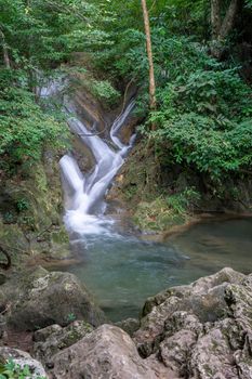 Clean green emerald water from the waterfall Surrounded by small trees - large trees,  green colour, Erawan waterfall, Kanchanaburi province, Thailand