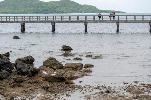 Rocks in the sea on the back, overlooking the original bridge, overlooking the Sattahip seaside.