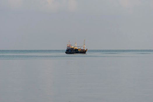 A small fishing boat is anchored. Stop back from Fishing near the coast