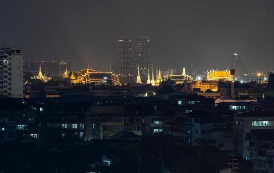 The capital city of Thailand is decorated with bright lights at night. Visible from a distance
