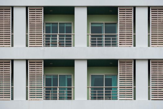 Duplicates of windows and balconies, condos, part of the green building.