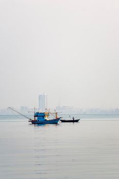 A small fishing boat is anchored. Stop back from Fishing near the coast
