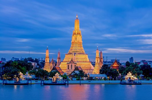 Arun Worawihan Temple Located on the Chao Phraya River, Thailand. At night the light illuminates the beautiful water.