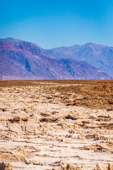 Devil's golf course in Death Valley National Park, with rough surface some covered by white salt