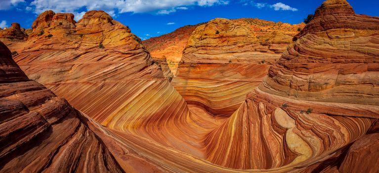 The Wave is a famous sandstone rock formation located in Coyote Buttes, Arizona, known for its colorful, undulating forms