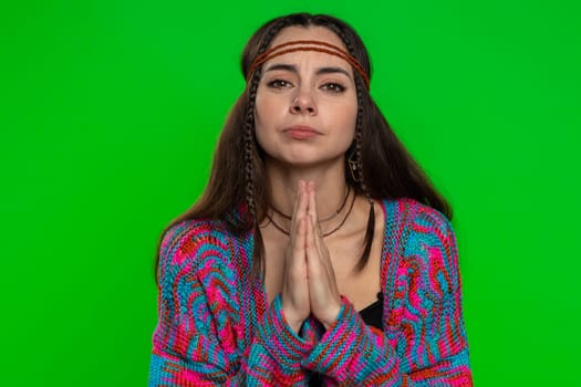 Please, God help, forgive me. Young woman, looking upward and making wish, asking with hopeful imploring expression, begging apology. Pretty hippie girl isolated on chroma key background, green screen