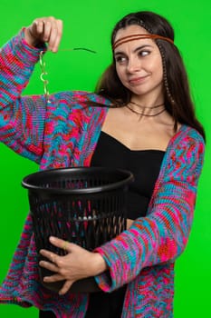 Hippie woman taking off throwing out glasses into bin after medical vision laser treatment therapy surgery looking smiling at camera. Pretty girl isolated alone on chroma key background, green screen
