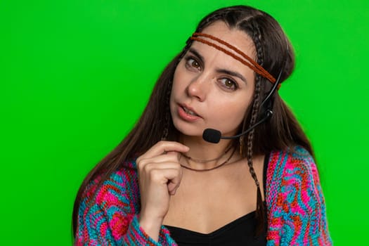 Smiling woman wearing headset, freelance worker, call center or support service operator helpline, having talk with client or colleague, communication support. Girl isolated on chroma key background