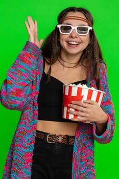 Excited young woman in 3D glasses eating popcorn and watching interesting tv serial, sport game, film, online social media movie content. Hippie girl isolated on chroma key background, green screen