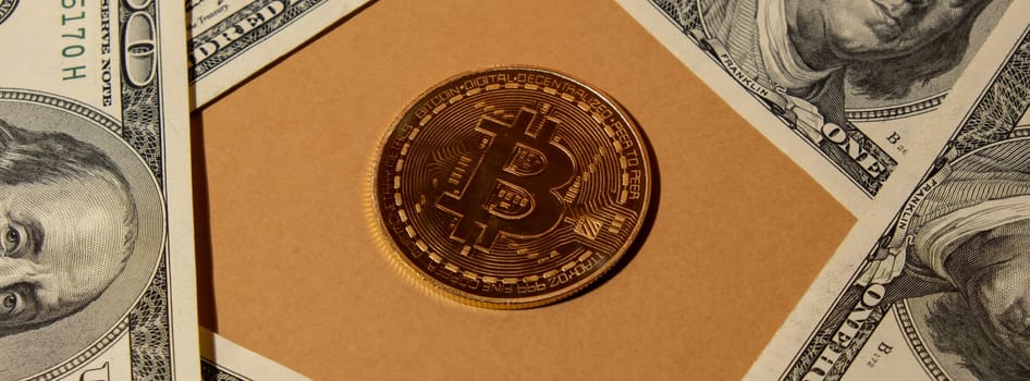 Bitcoin gold coin on bills of 100 dollars American currency. Bitcoin mining trading concept. BTC golden money. Worldwide virtual internet Cryptocurrency or crypto digital payment system. Digital coin money farm in digital cyberspace