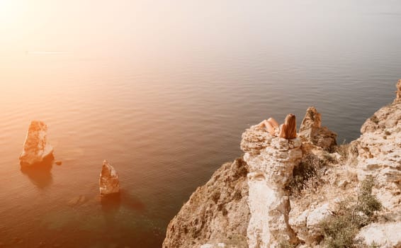 Woman travel sea. Happy tourist taking picture outdoors for memories. Woman traveler looks at the edge of the cliff on the sea bay of mountains, sharing travel adventure journey.