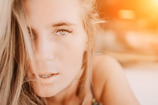 Happy woman portrait in cafe. Boho chic fashion style. Outdoor photo of young happy woman with long hair, sunny weather outdoors sitting in modern cafe