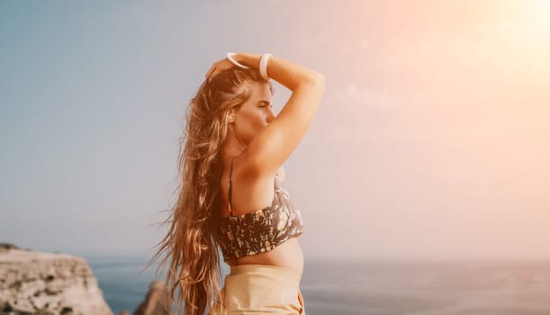 Woman travel sea. Happy tourist taking picture outdoors for memories. Woman traveler looks at the edge of the cliff on the sea bay of mountains, sharing travel adventure journey.