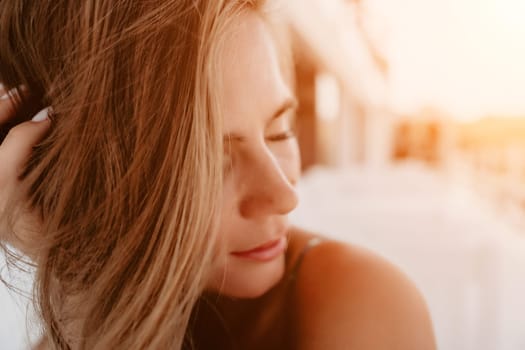 Happy woman portrait in cafe. Boho chic fashion style. Outdoor photo of young happy woman with long hair, sunny weather outdoors sitting in modern cafe