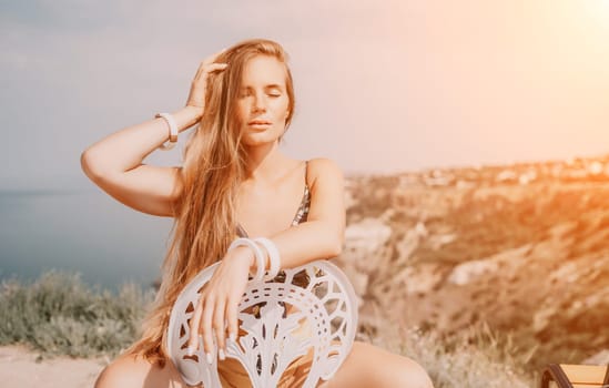 Happy woman portrait in cafe. Boho chic fashion style. Outdoor photo of young happy woman with long hair, sunny weather outdoors sitting in modern cafe