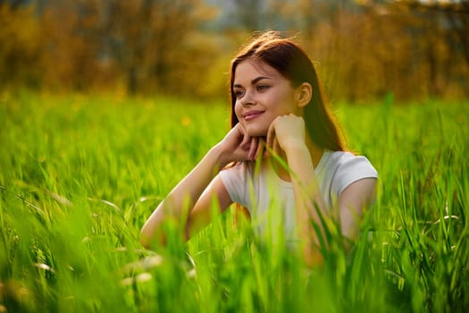 portrait of a happy woman in a white t-shirt with her hands folded in front of her face. High quality photo