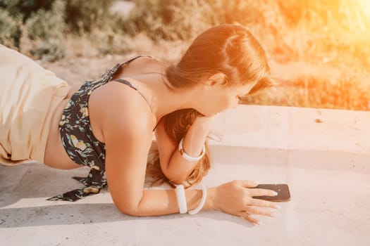 Woman park yoga. Side view of free calm bliss satisfied woman with long hair standing in morning park with yoga position against of sky by the sea. Healthy lifestyle outdoors in park, fitness concept