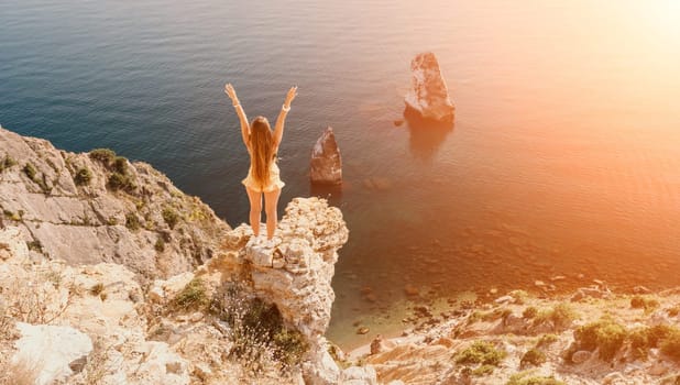 Woman travel sea. Happy tourist taking picture outdoors for memories. Woman traveler looks at the edge of the cliff on the sea bay of mountains, sharing travel adventure journey.