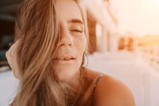 Happy woman portrait in cafe. Boho chic fashion style. Outdoor photo of young happy woman with long hair, sunny weather outdoors sitting in modern cafe