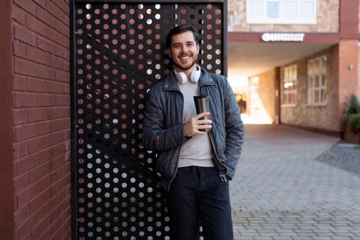 smiling european male blogger outdoors in spring clothes.