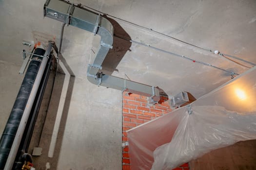 Repair and restoration of apartment drainpipes and ventilation. Empty room without decoration