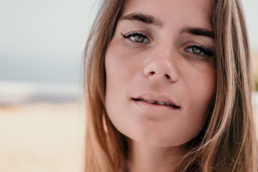 Happy woman portrait in cafe. Boho chic fashion style. Outdoor photo of young happy woman with long hair, sunny weather outdoors sitting in modern cafe