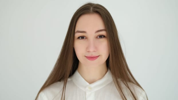 Portrait of young caucasian woman with long hair on white background. Healthy lifestyle concept