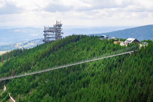 Sky walk observation tower in the forest between mountain hills near Sky Bridge 721 in a sunny summer day, Dolni Morava, Czech Republic.