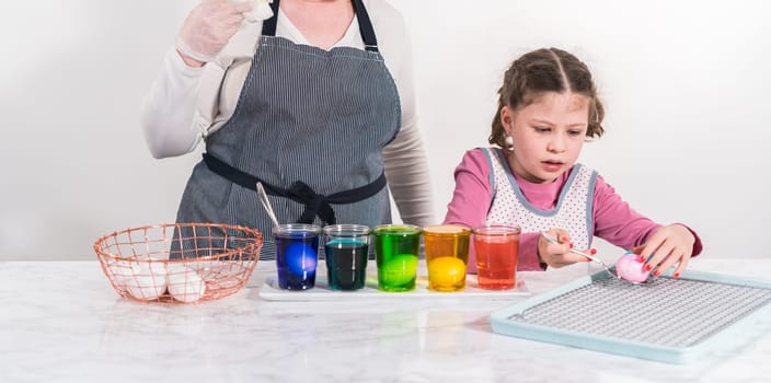 Easter egg coloring. Dye white organic eggs in different colors for Easter.