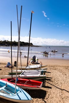 Colorful boats on beautiful sea beach in sunny day. Fishing and travel transportation ships on scenic seascape