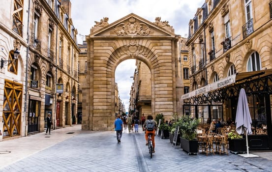 Bordeaux, France - 28 August 2022: Old gate arch on a street in the center of Bordeaux