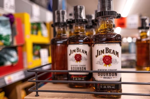 Whiskey Jim Beam bottles in supermarket closeup. Alcohol strong beverage for party in store. Poznan, Poland, 2020-09-06