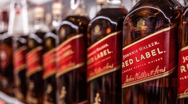 Whiskey Red Label bottles in supermarket closeup. Alcohol strong beverage for party in store. Poznan, Poland, 2020-09-06