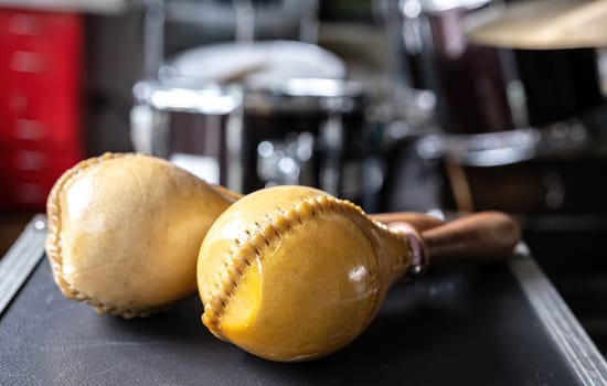 Wooden maracas for hispanic music on table in recording studio closeup. Traditional shaking musical instrument for ethnic perfomance