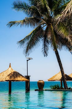 A beach scene with a palm tree and a beach hut.
