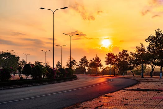 A road with a sunset in the background.