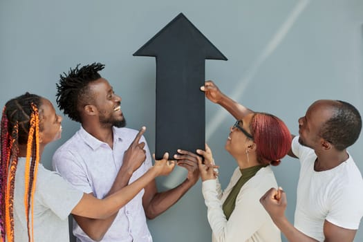 Business Team Holding black arrow together