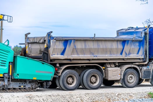 machine asphalting of roads. truck with asphalt. the creation of a new transport communication and infrastructure. High quality photo