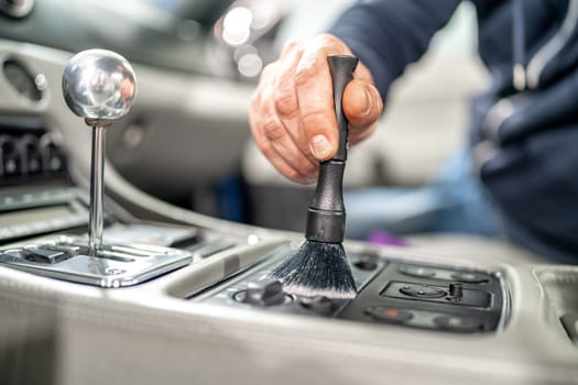 cleaning the interior of a luxury car with a brush. High quality photo