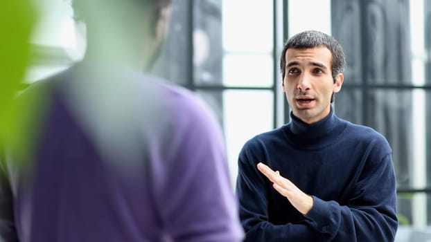 young african american and caucasian business people discussing common project work