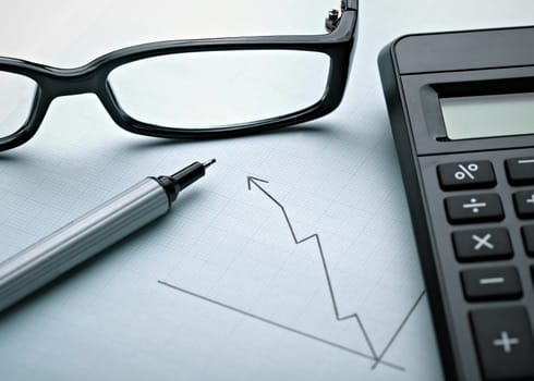 close up of a business finance graph, papers and pencil