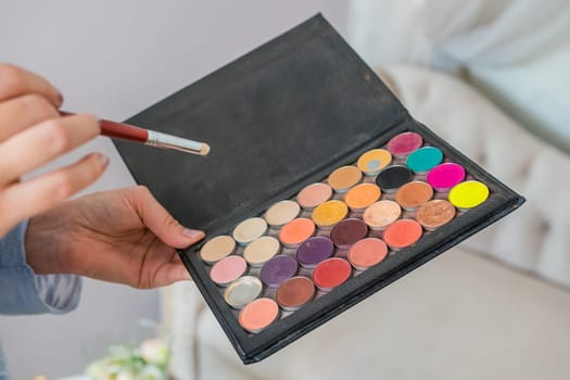 Makeup powder in the hands of a makeup artist
