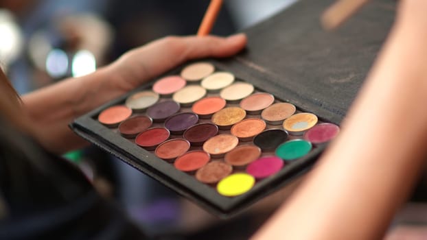 Makeup powder in the hands of a girl makeup artist