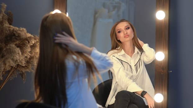 Beautiful girl model posing in front of a mirror