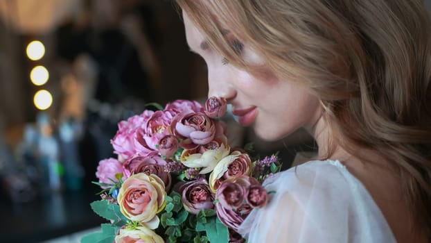 Beautiful young girl with a bouquet of flowers.