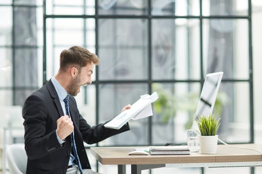 energetic businessman celebrating in office