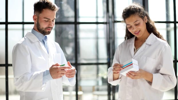 doctors read the dosage of the drug while standing in the lobby of the hospital